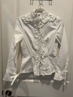 iROO ruffled blouse featuring a high collar. Size 38. New.